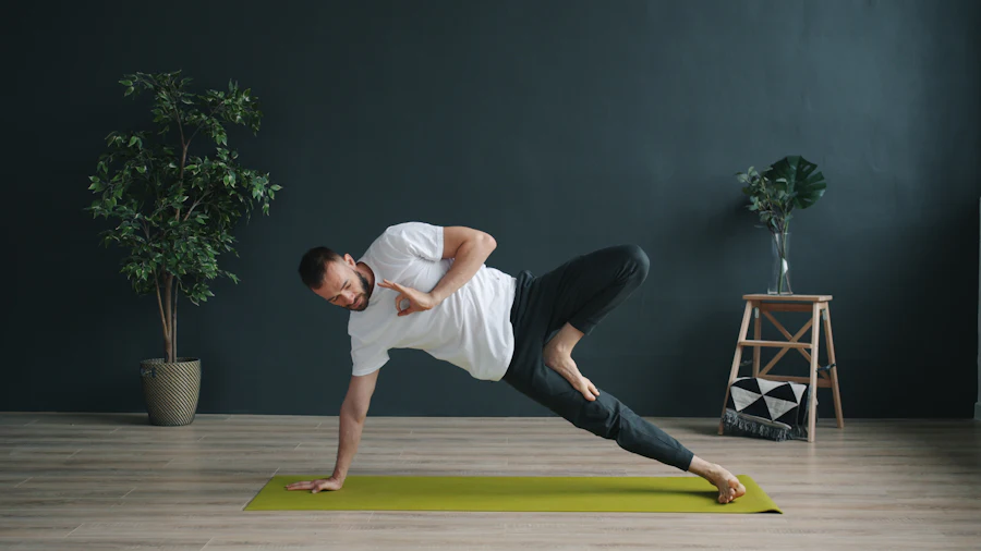 A man holding a side plank on a yoga mat