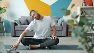 Man doing neck stretches on yoga mat at home