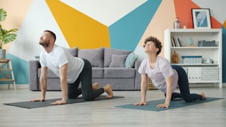Couple doing yoga cat-cow pose at home