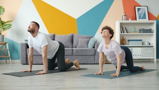Couple doing yoga cat-cow pose at home