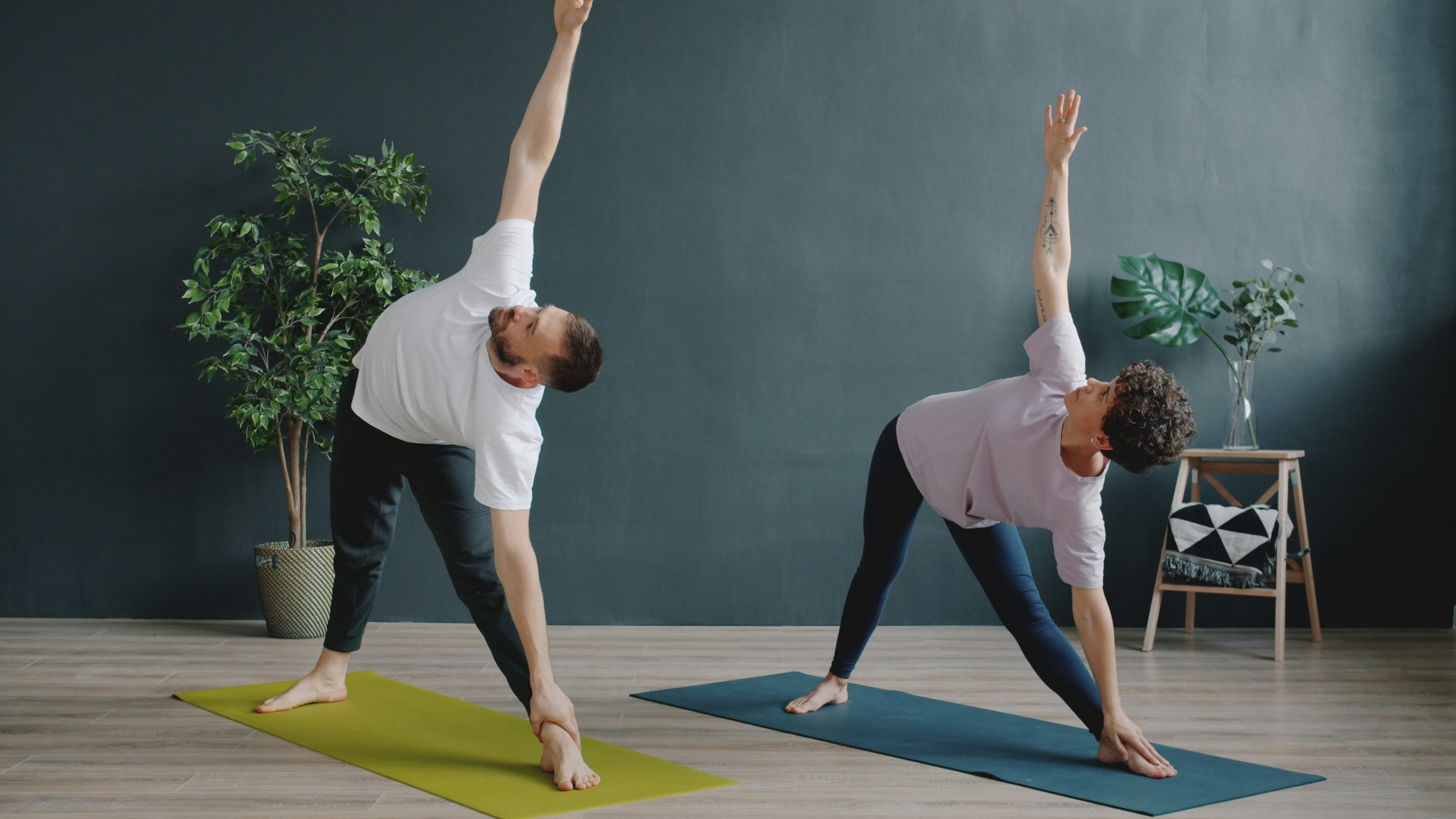 Couple doing yoga in modern room