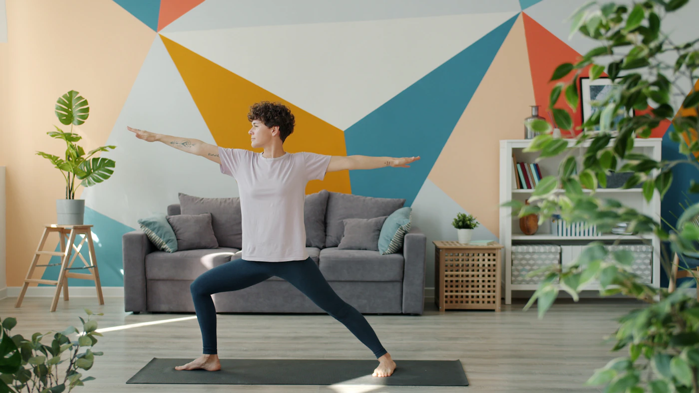 Woman practicing a gentle standing pose at home