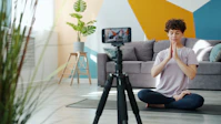 Woman meditating in front of a phone camera