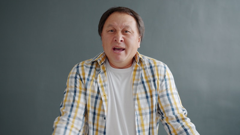 Charismatic man in plaid shirt speaking