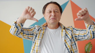 Man giving two thumbs down gesture