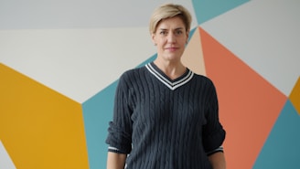 Woman with short blonde hair in a sweater.