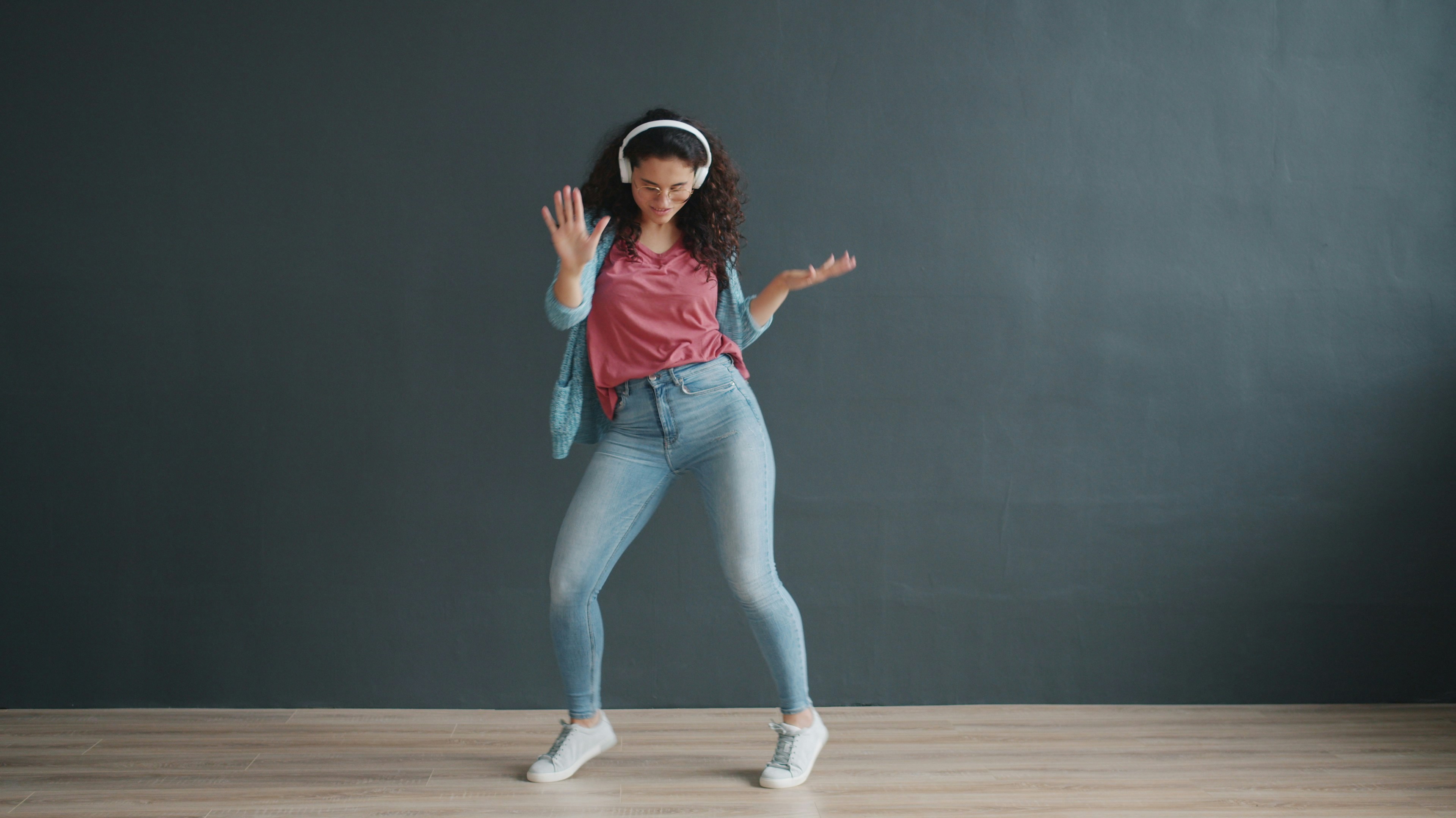 Young woman dancing with headphones on