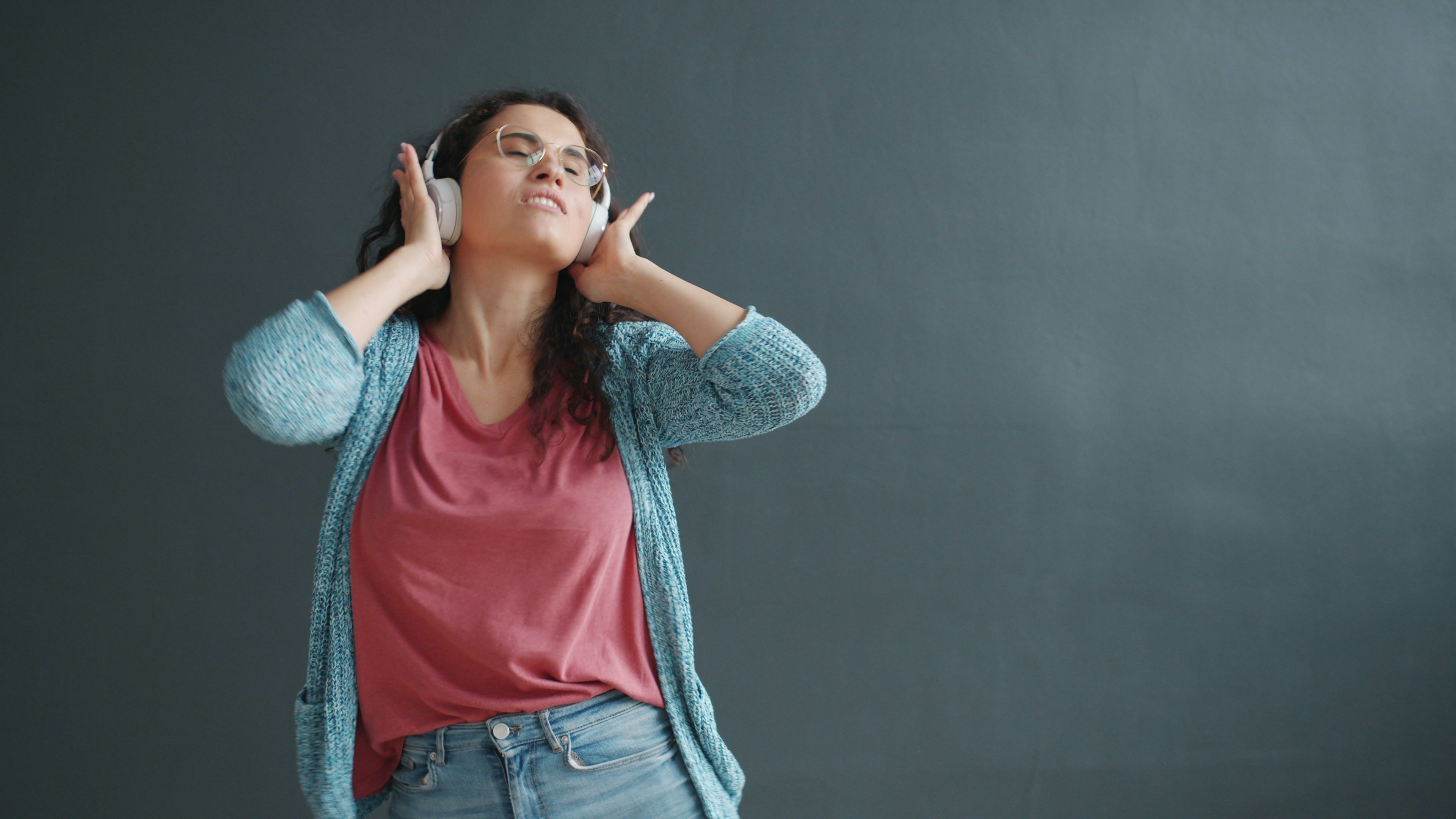 Woman with headphones enjoying music with eyes closed