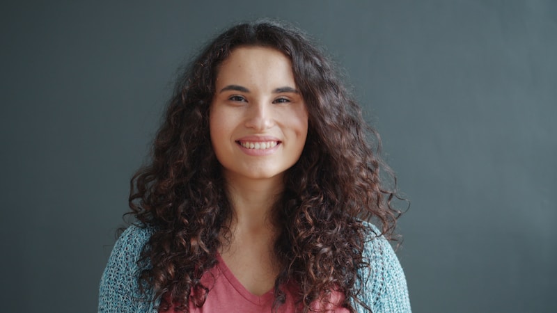 Confident woman with curly hair smile