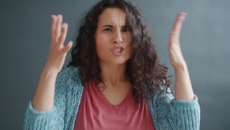 Woman with curly hair looking angry and frustrated.