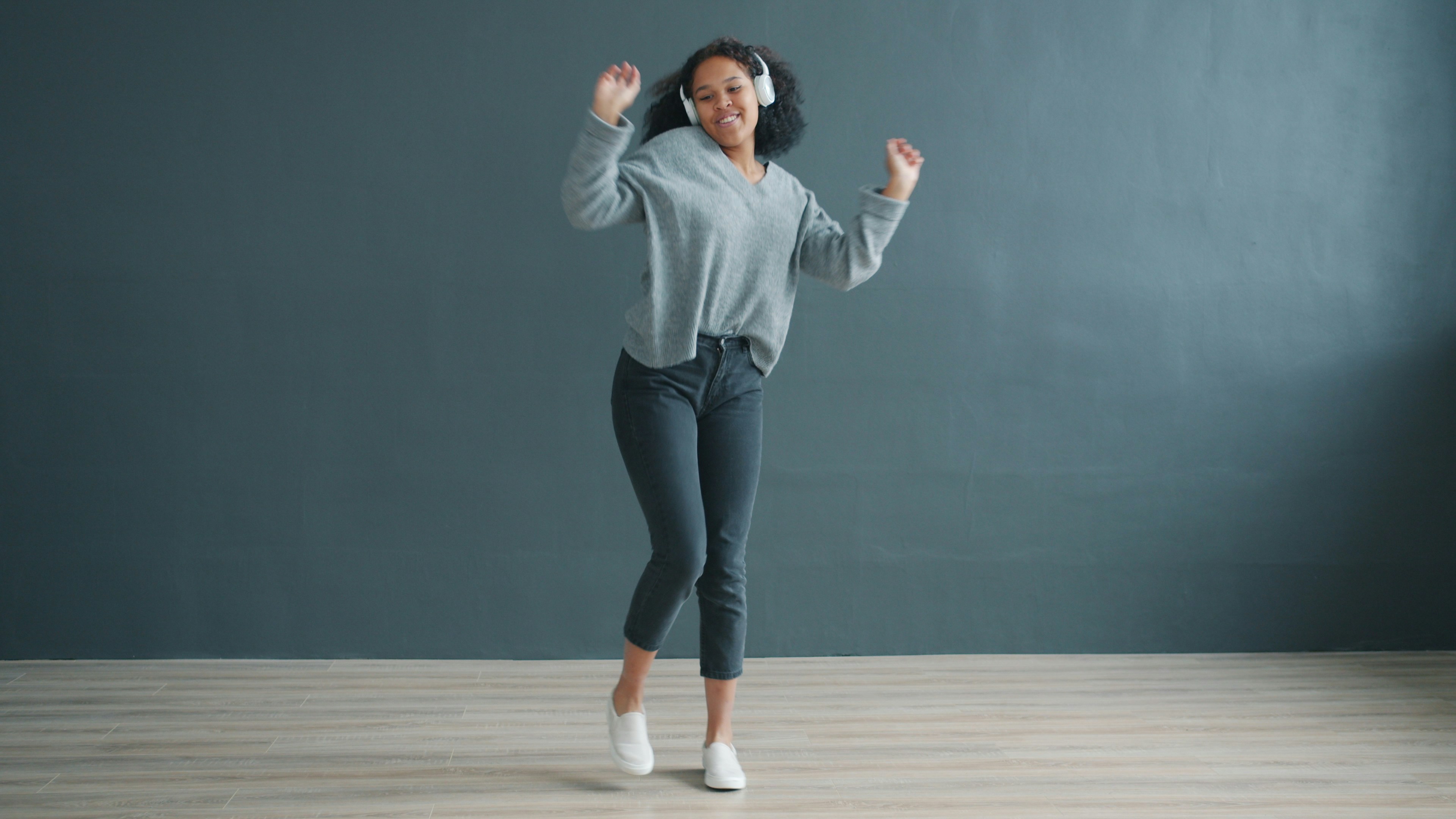 person looking energized and happy mid-dance move - hip hop fitness classes near me