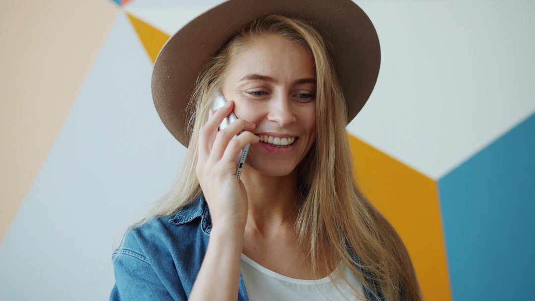 A smiling woman talking on her phone
