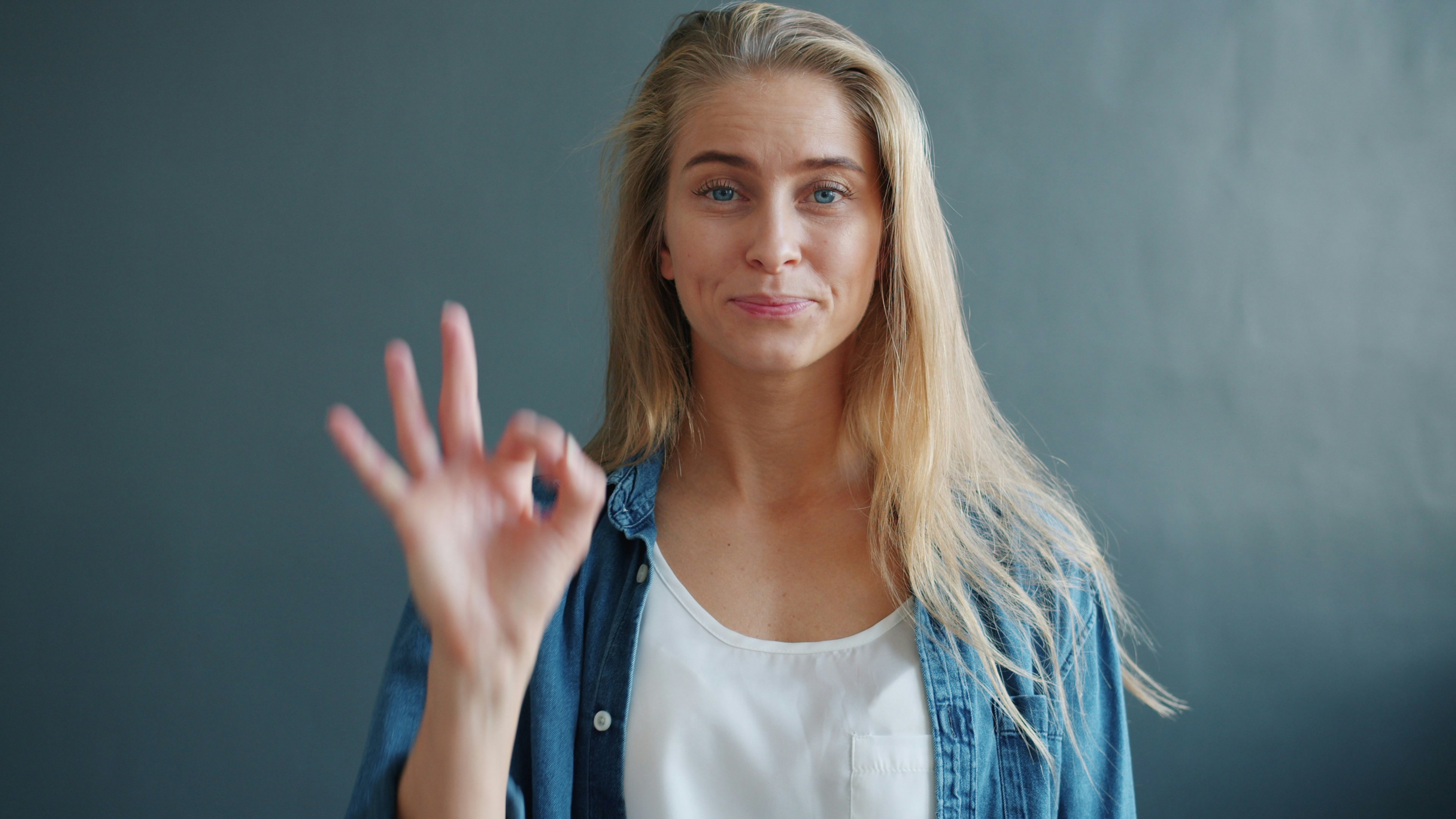 Woman making the OK gesture with her hand