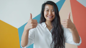 Woman giving two thumbs up with a smile