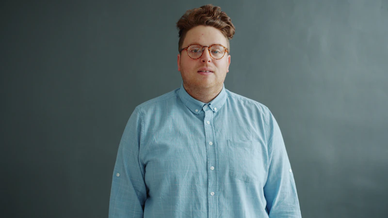 person wearing blue shirt and glasses
