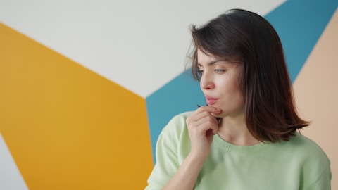 A young woman looking thoughtfully to the side.