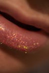 Close-up of lips with pink glitter makeup.