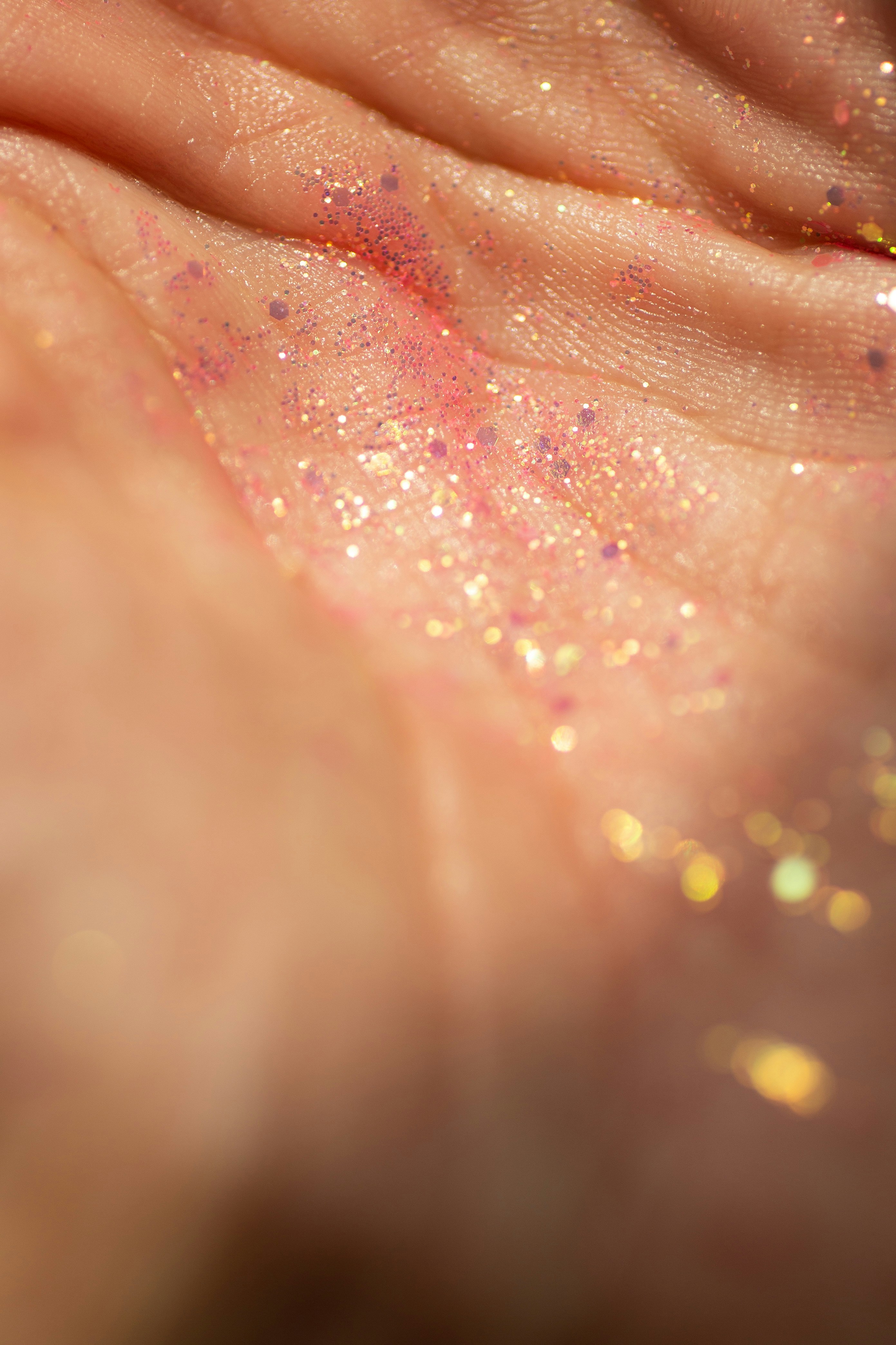 Close-up of glitter on a person's hand