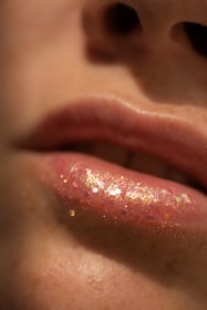 Close-up of a person's lips with glittery lip gloss.