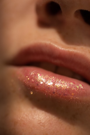 Close-up of a person's lips with glittery lip gloss.