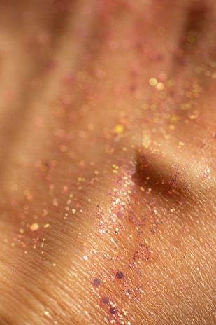 Close-up of skin with pink and gold glitter.