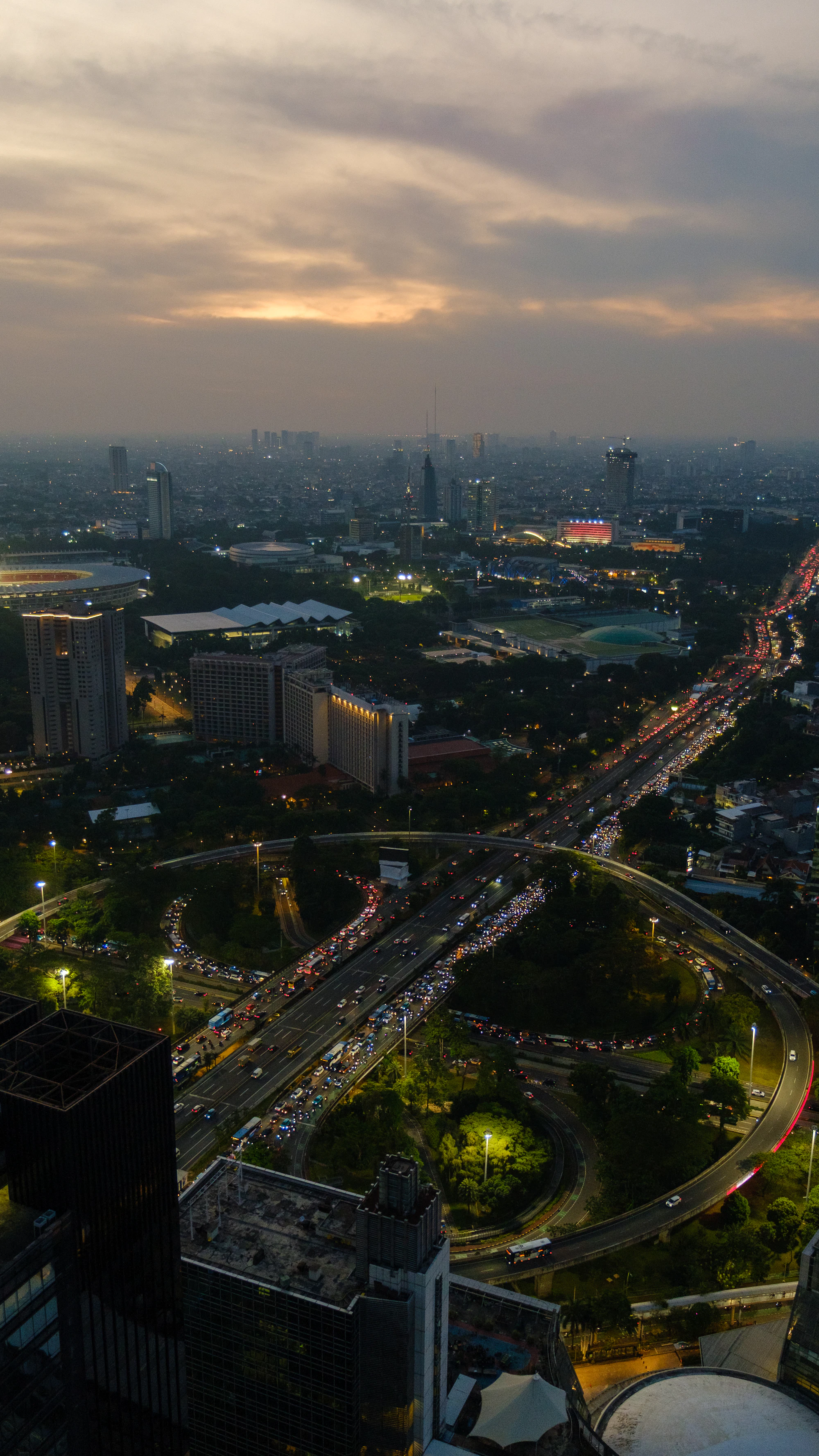 Urban interchange at dusk with traffic light trails