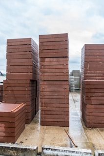 Stacks of red paving stones on a wet surface