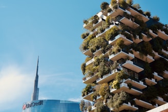 Modern building with balconies covered in lush greenery.