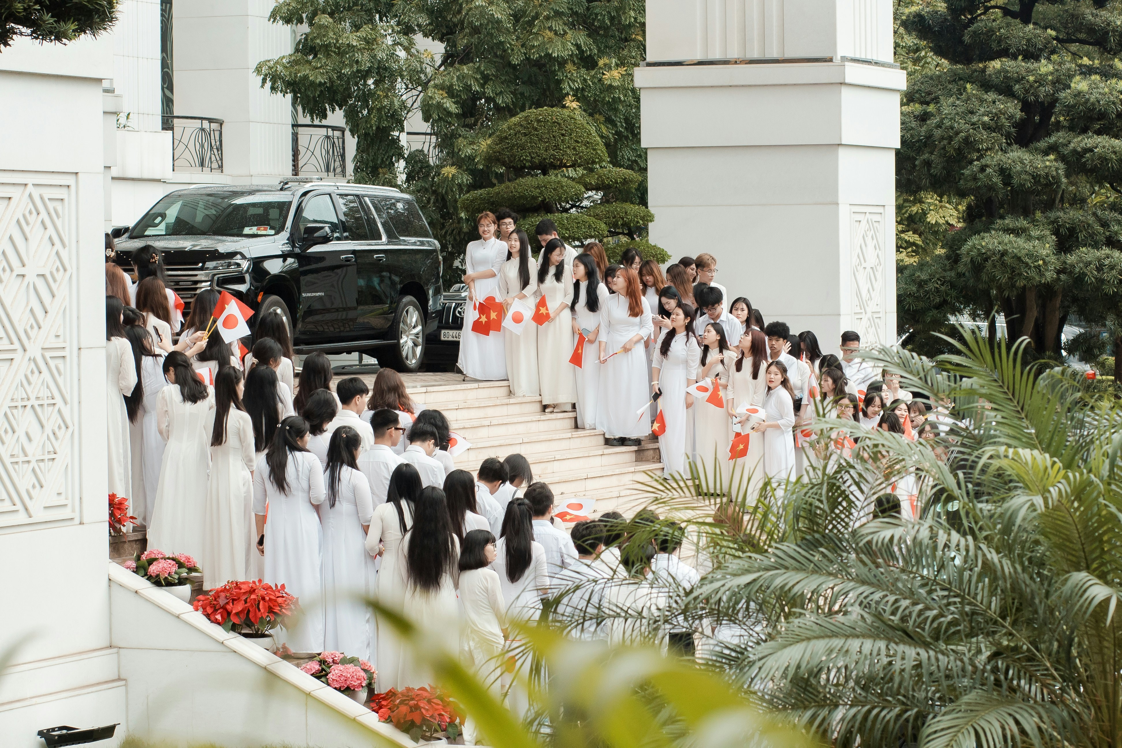 Group of women in white dresses walking down stairs
