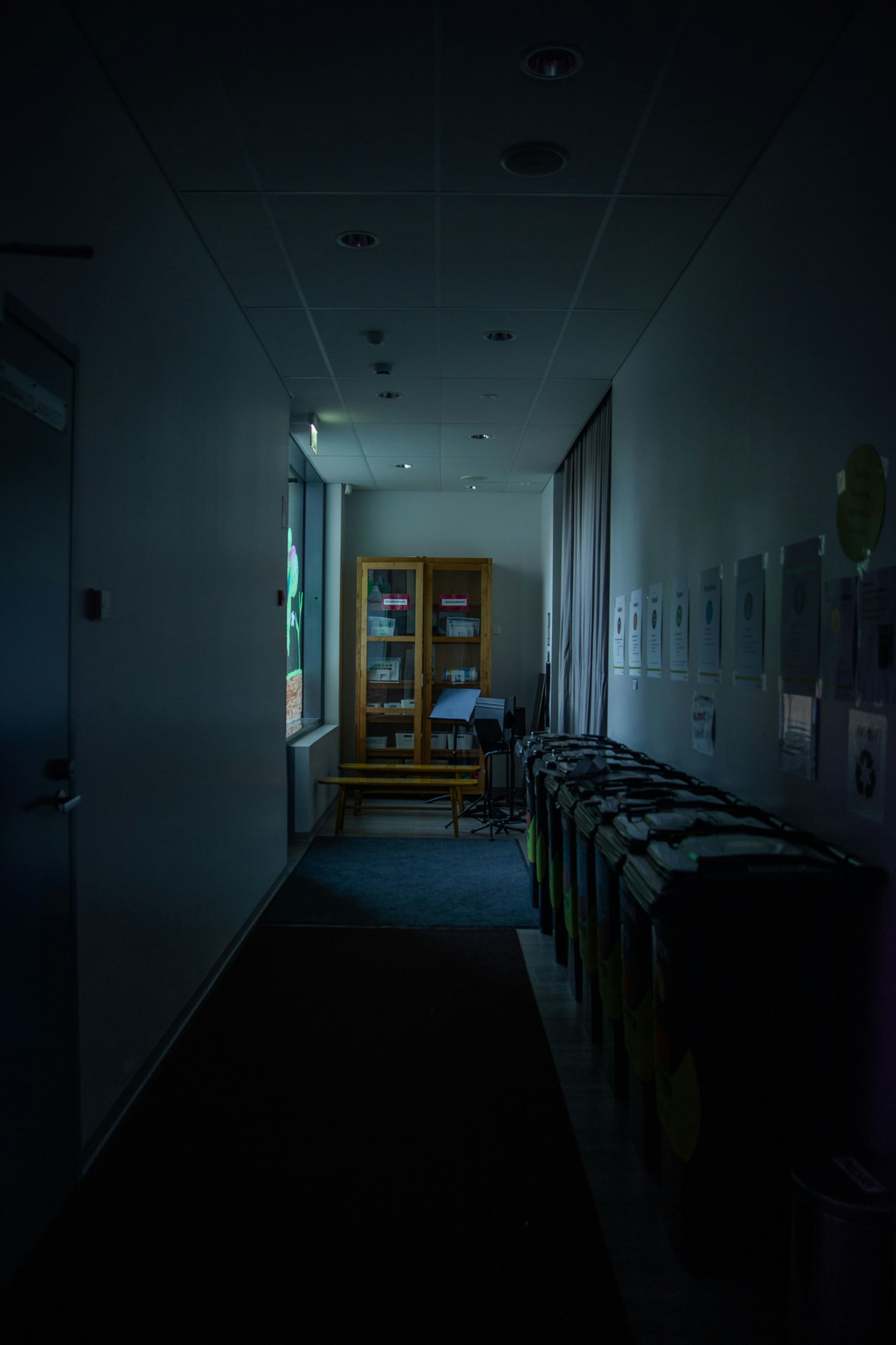 ロッカーとキャビネットのある薄暗い廊下