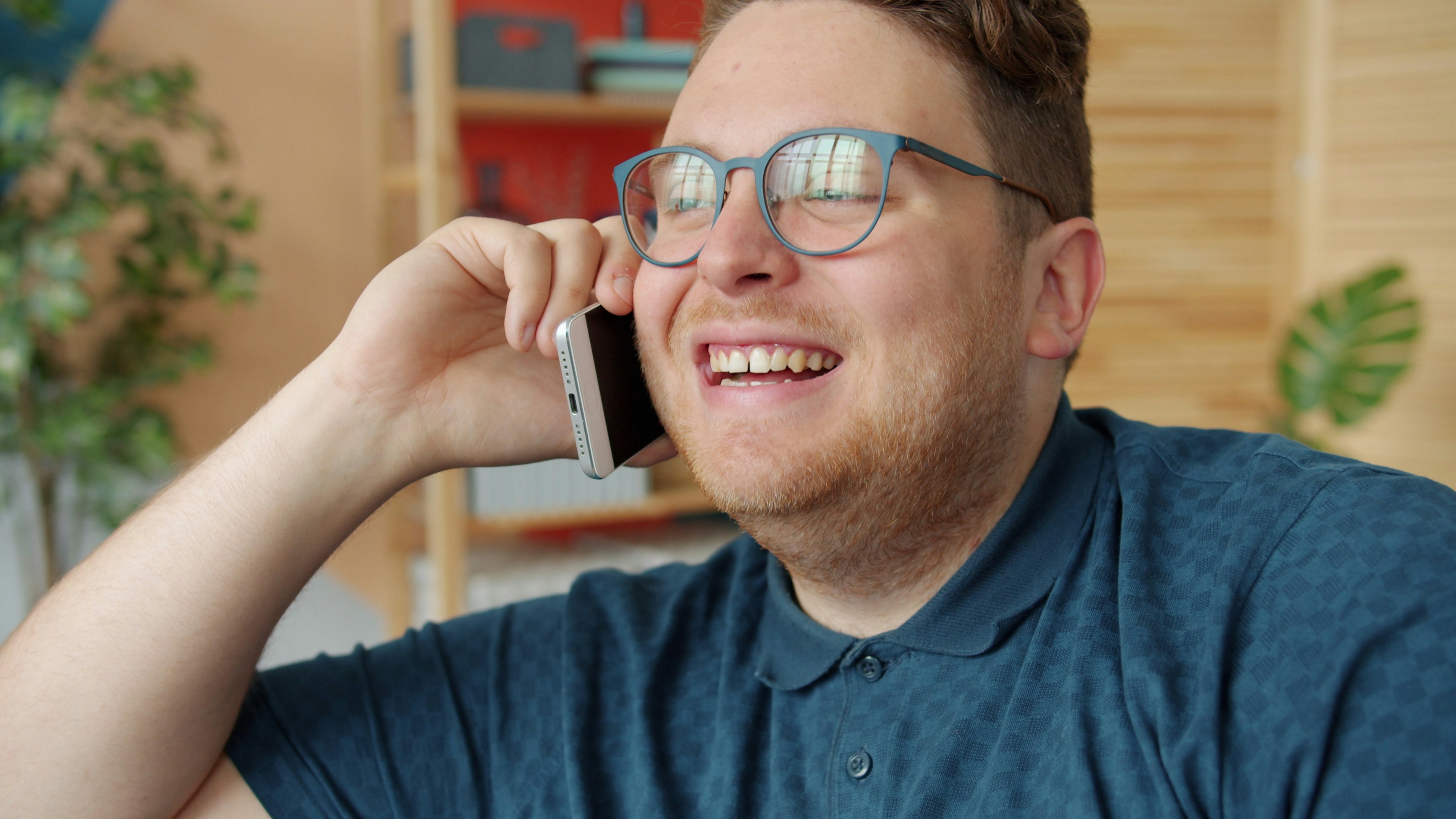 Man in glasses talking on a cell phone