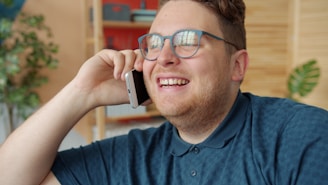 Man in glasses talking on a cell phone