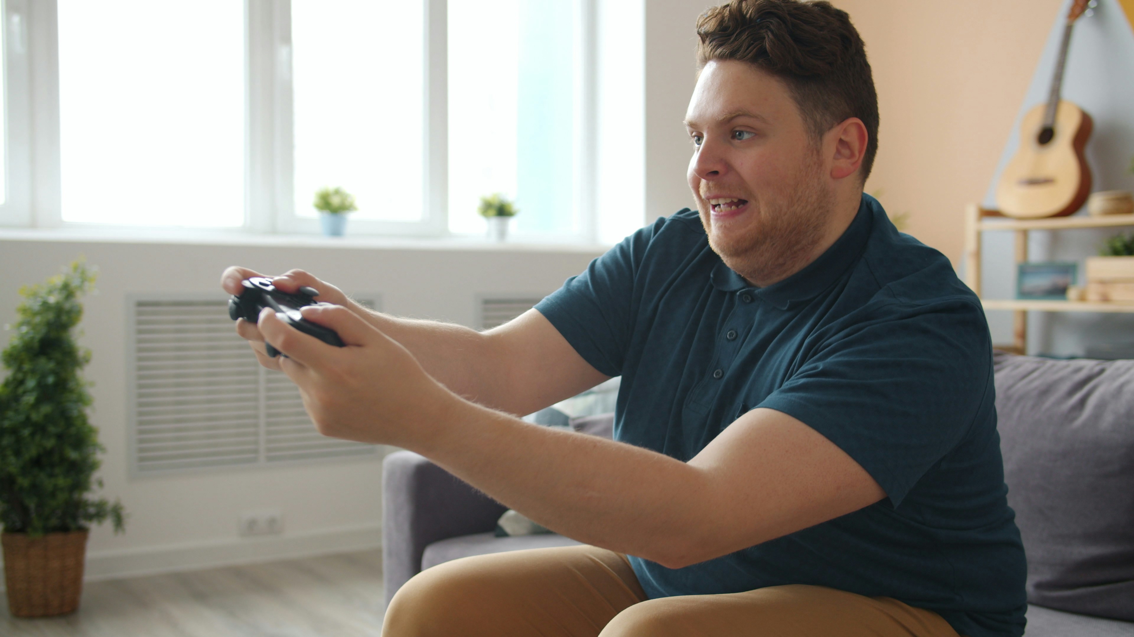Man playing video games on a couch