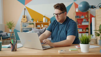 Man working on a laptop at a desk.