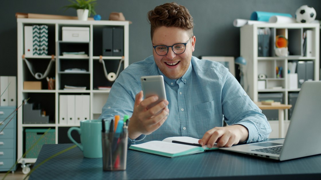 Person using smartphone at desk — reviews and reputation Cochrane