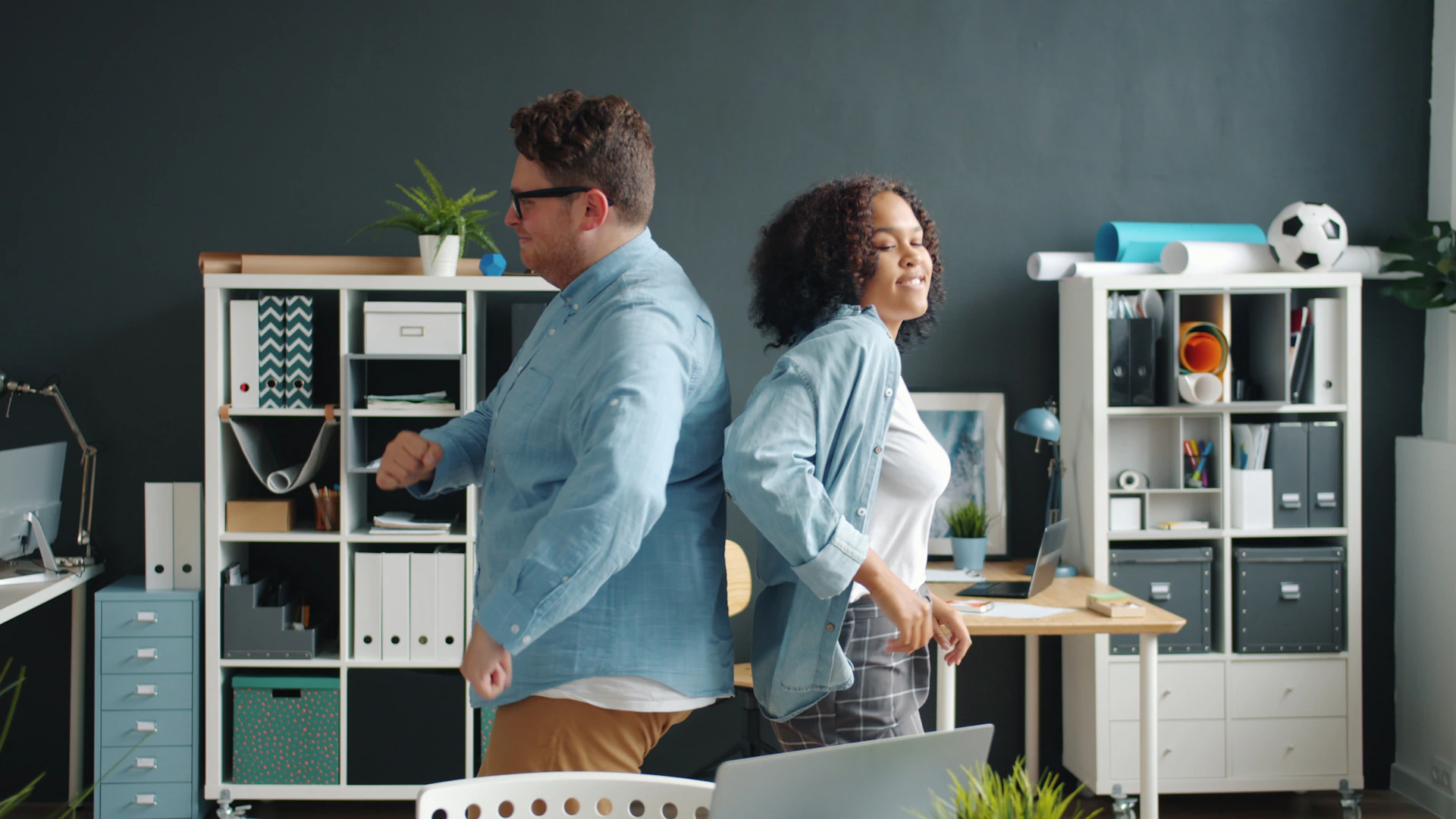 Man and woman back to back in office