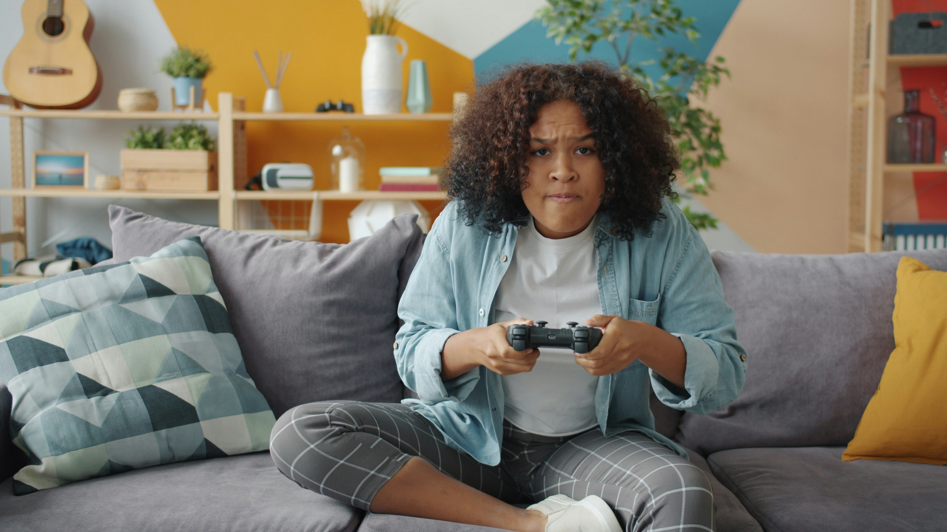 gamer hands holding Xbox wireless controller in modern living room