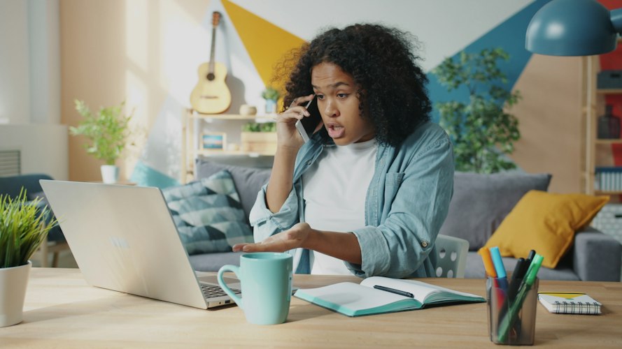Freelancer reviewing a simple spreadsheet of client leads on a laptop screen