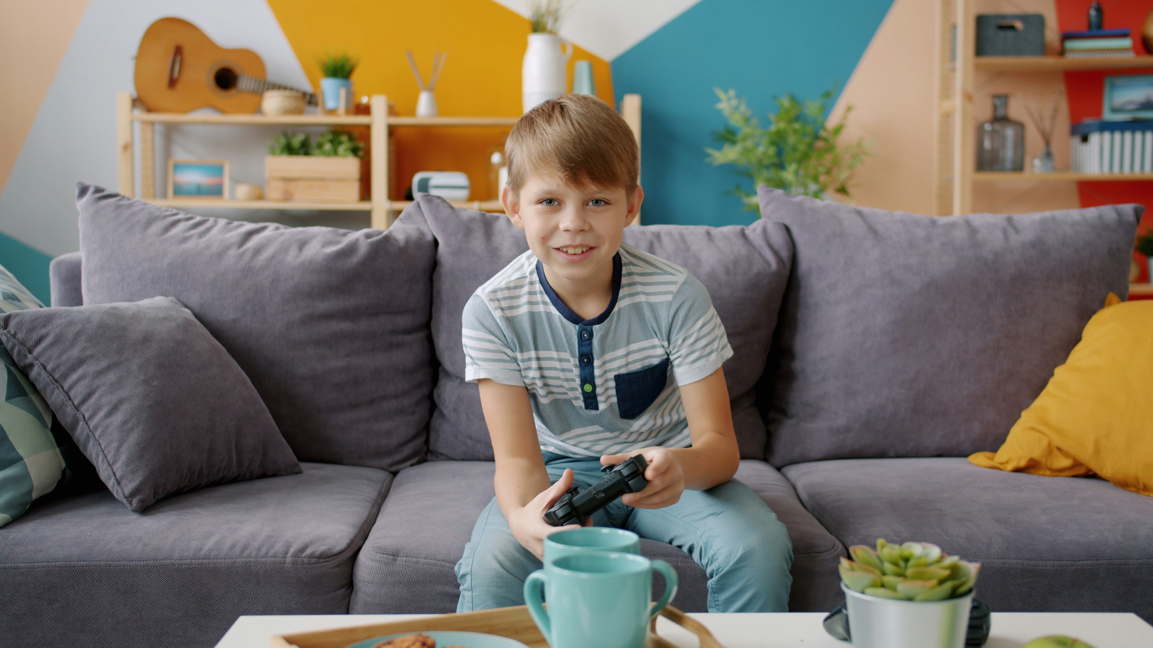 Boy playing video games on couch