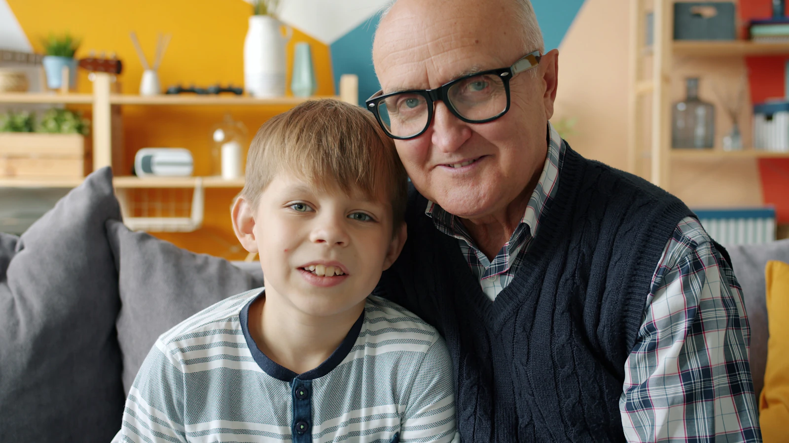 Grandfather and grandson smiling together at home