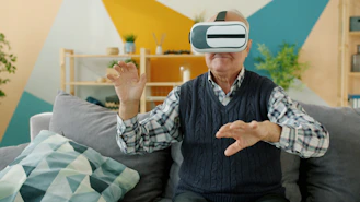 Elderly man using virtual reality headset at home