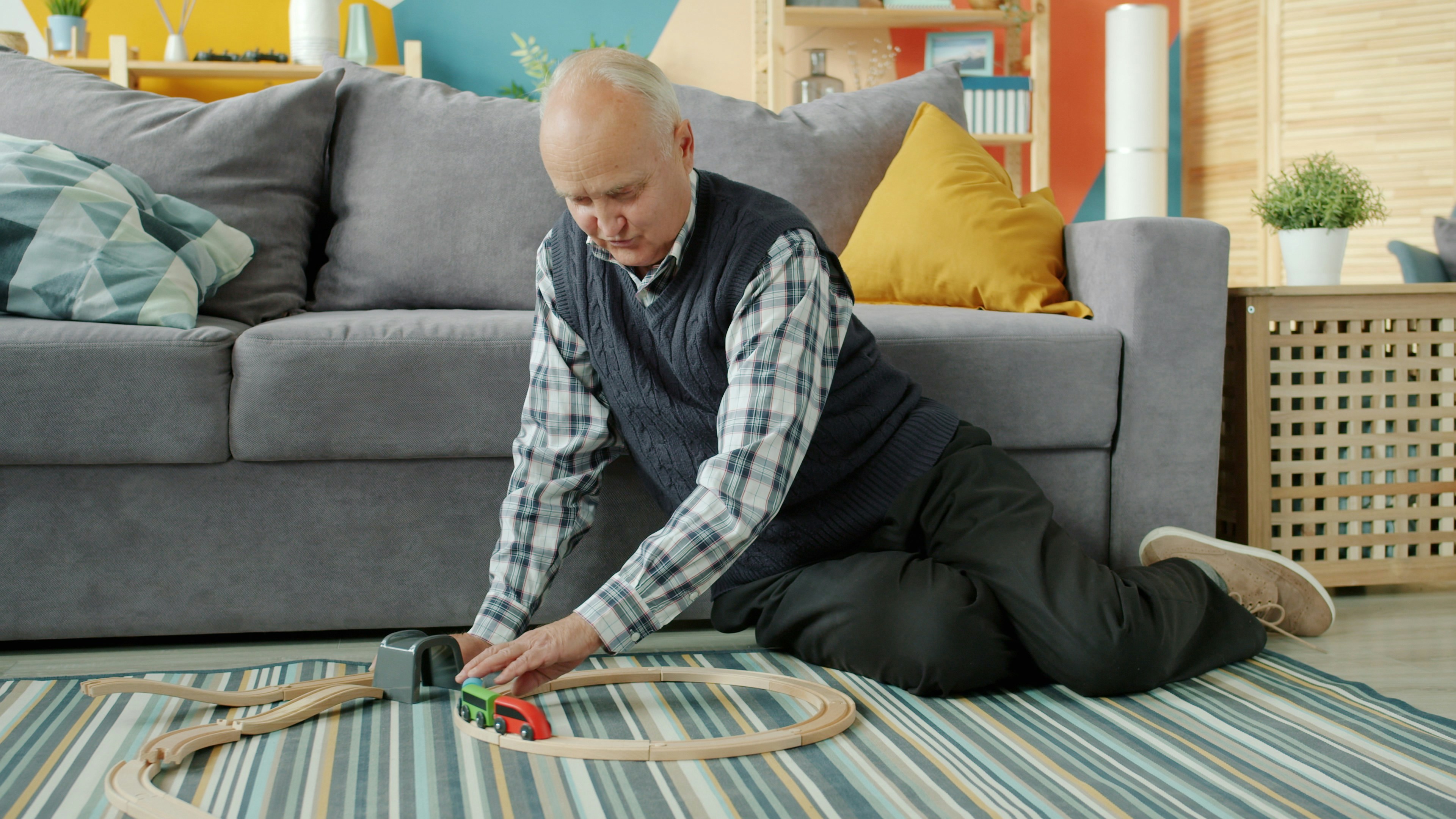 Senior man playing with toy cars