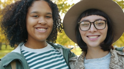 Two smiling young women in an outdoor setting