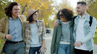 Four friends walking together in a park