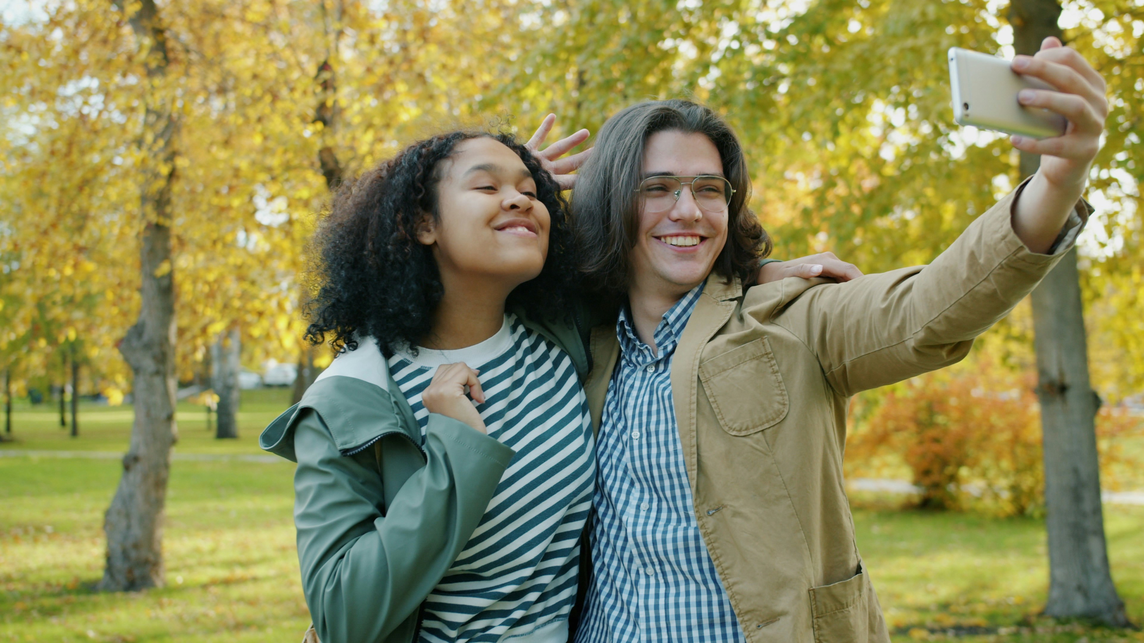 Couple taking a selfie in autumn park