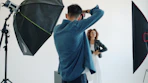 Photographer taking picture of model in studio.