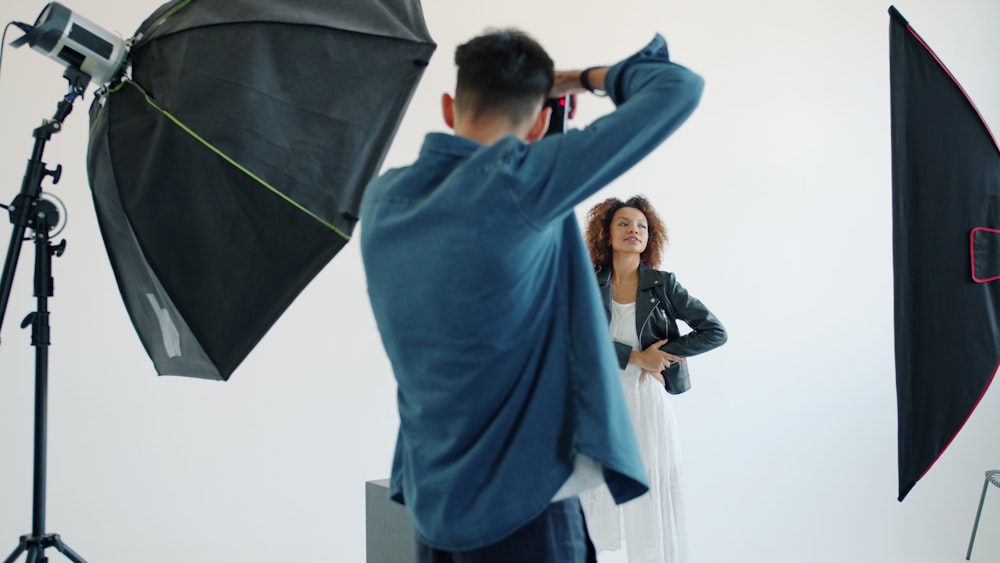 Professional fashion photographer working in a studio with professional lighting equipment