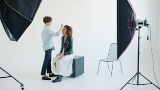 Makeup artist applying makeup to a model in studio