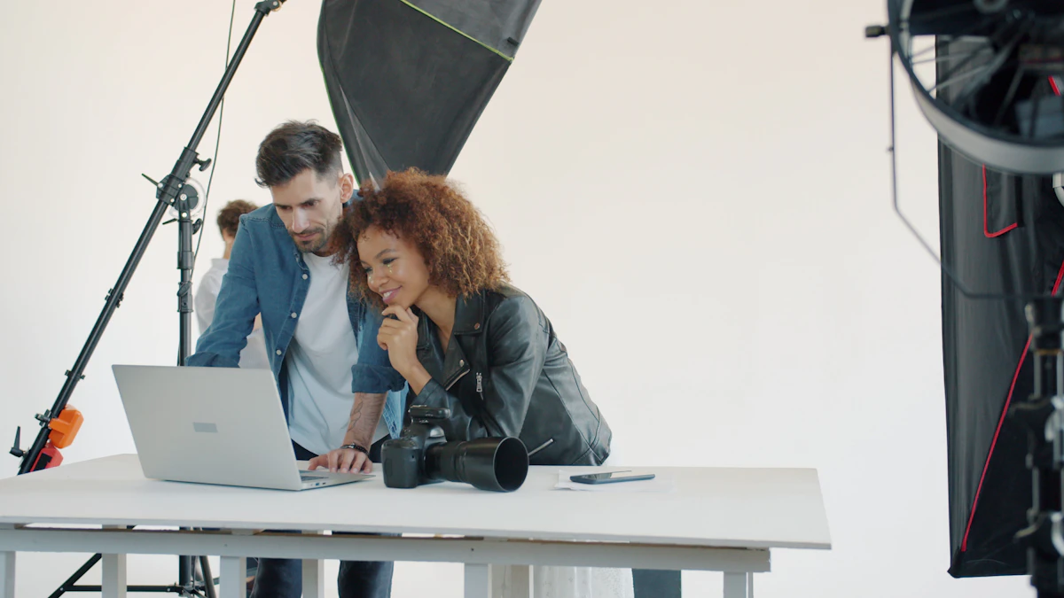 Two people looking at a laptop in a photography studio