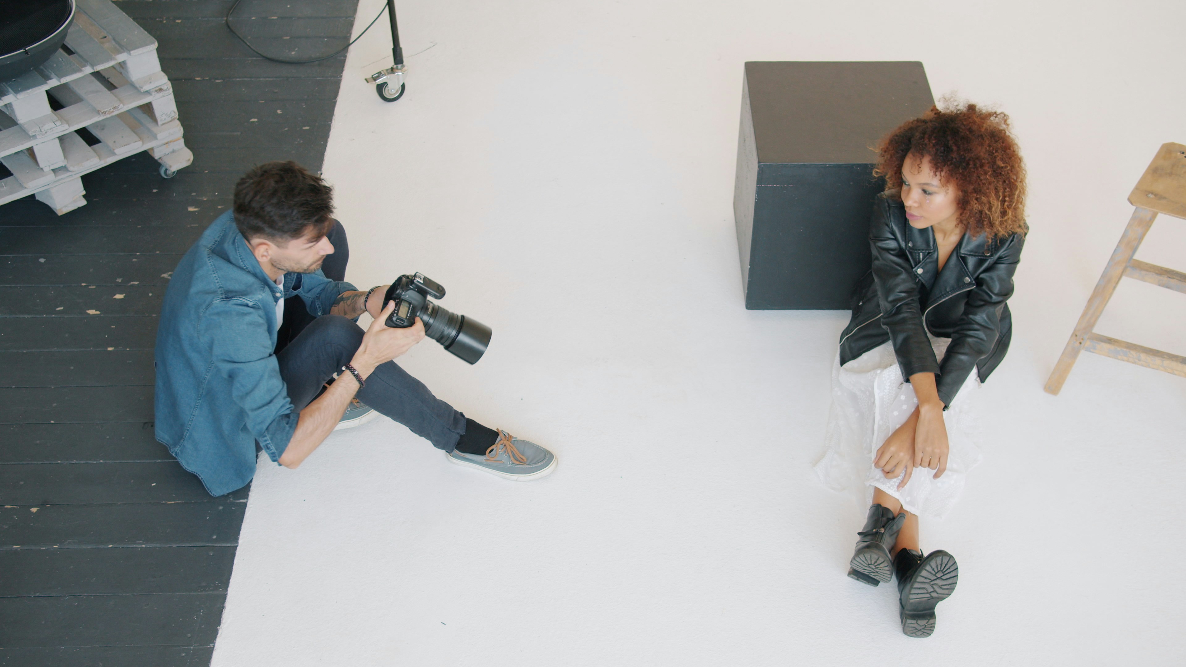 Photographer capturing an image of a woman in studio lighting